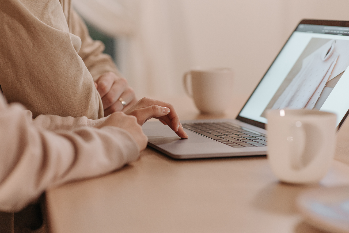 Person using laptop with coffee cups